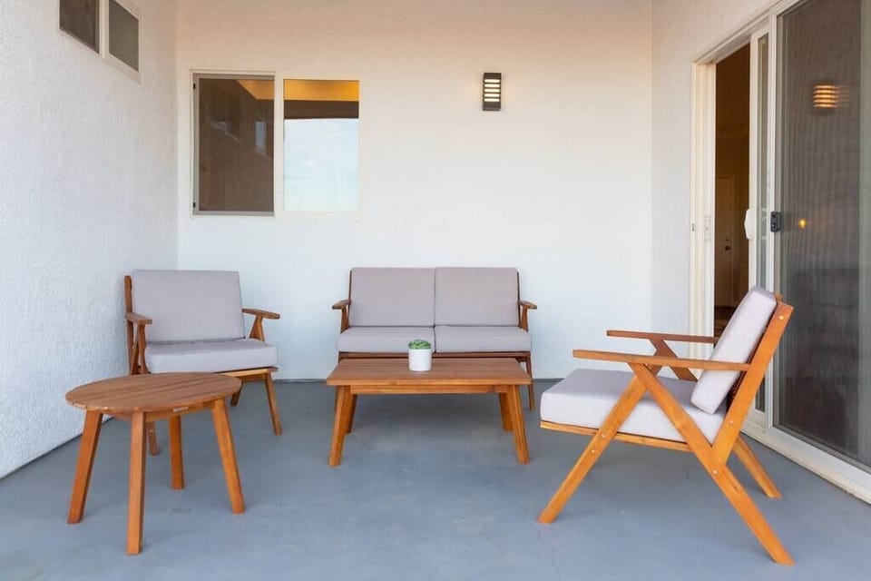 Covered porch for outdoor relaxation with stylish patio furniture.