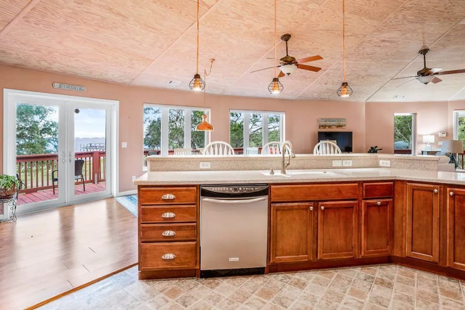 Equipped kitchen includes dishwasher, kitchen sink with a view.