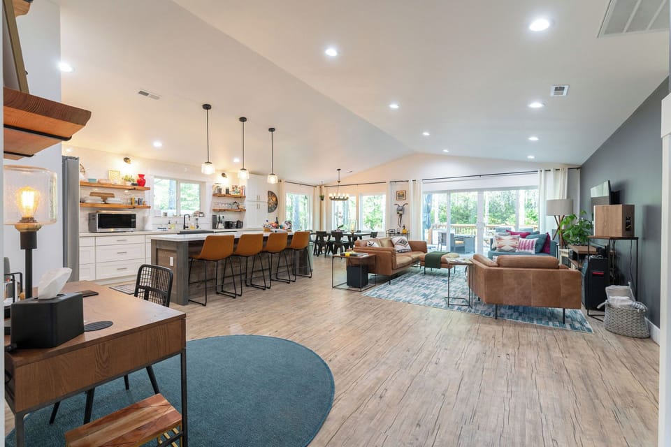 The Great room has desk space a full chef's kitchen, dining table and living room. 