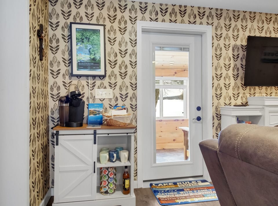 Stocked morning coffee bar as you go out onto the 4-seasons room view of lake!