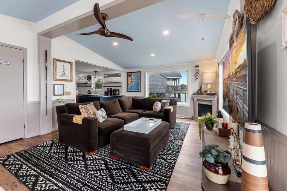 Comfortable open-plan living room with vaulted ceilings.