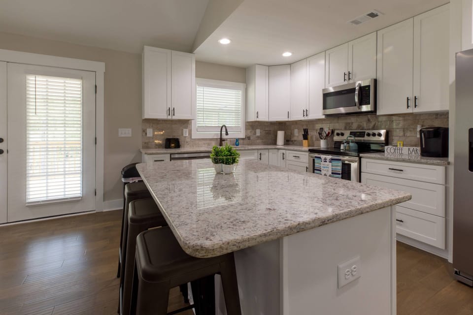 A large island and open kitchen make your family feel at home.