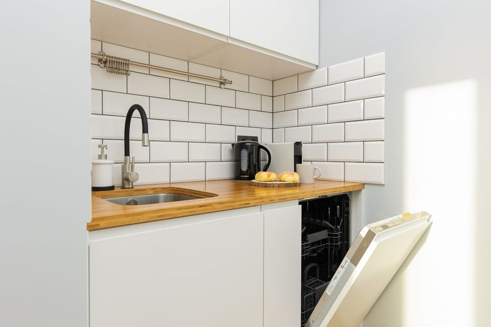 Another view of the compact yet functional kitchen, with open shelving for storage.






