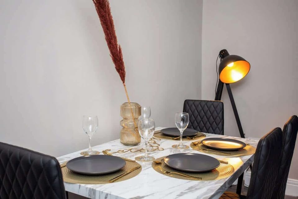 Bathed in soft light, the sleek dining table offers ample seating for gatherings of family and friends.