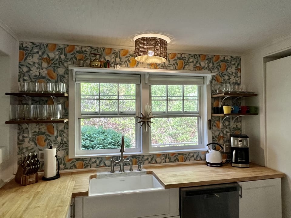 Farmhouse kitchen sink, dishwasher, and butcher block counter tops.