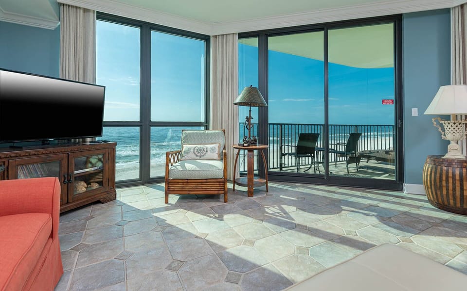 Relax in this inviting living area with a view, featuring sofa with queen sleeper and a large TV for entertainment