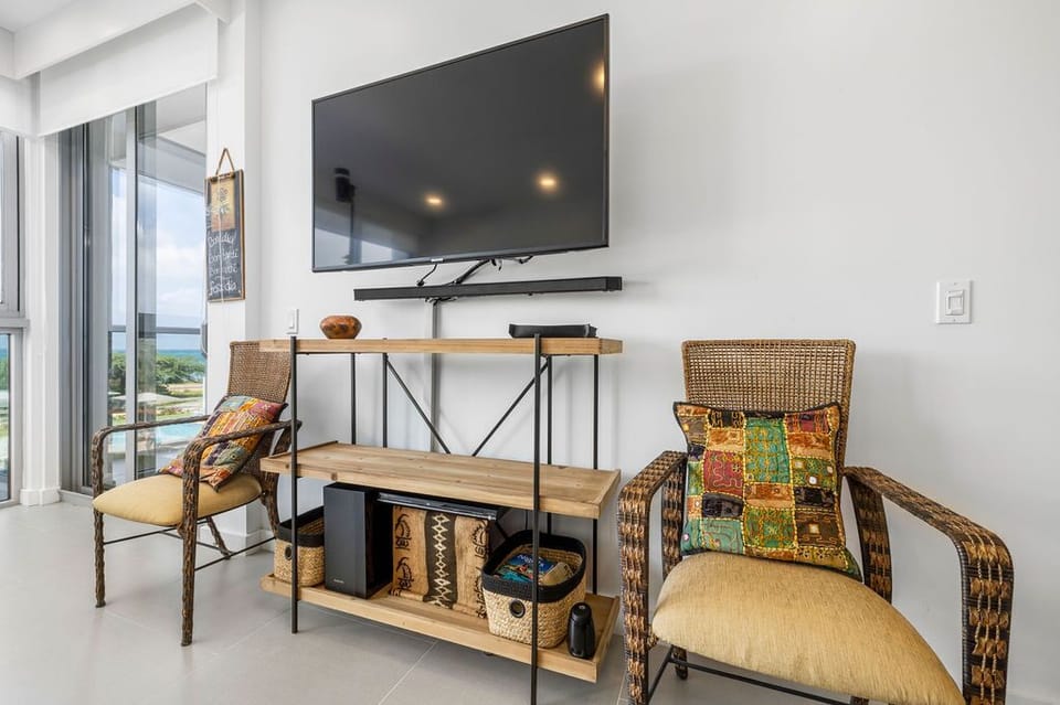 Settle into your bright living space with coastal views and colorful accents. Large screen TV and stylish shelving provide everything you need to relax after exploring.