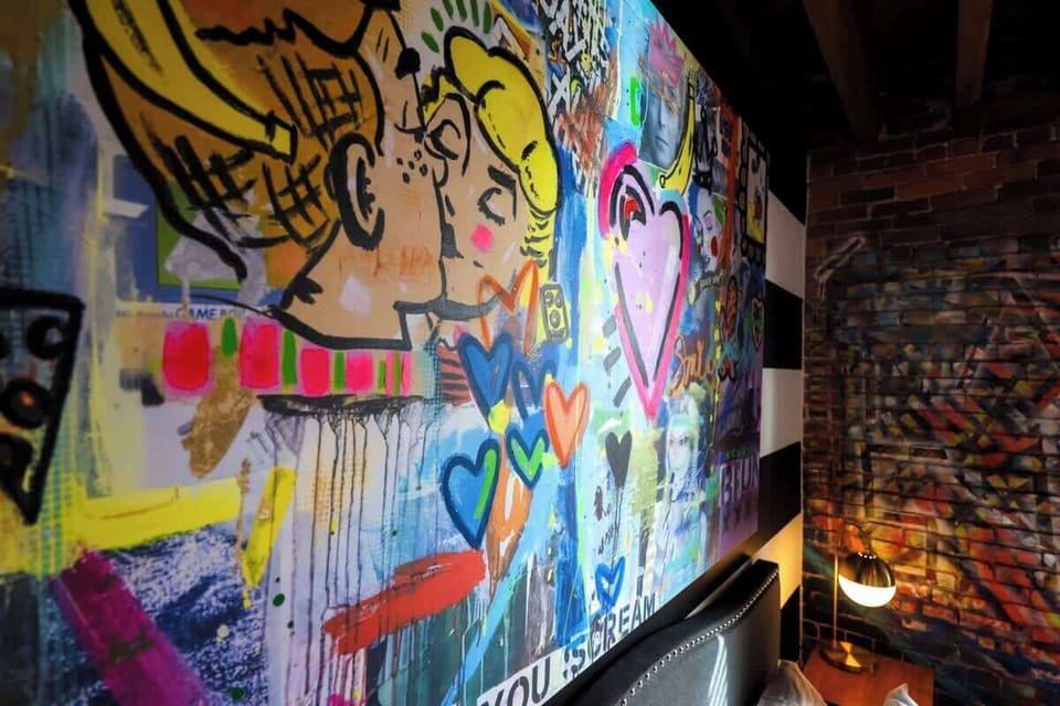 Sleeping in style! 🛏️ Who needs plain walls when you can wake up to vibrant graffiti art every morning? #BedroomGoals