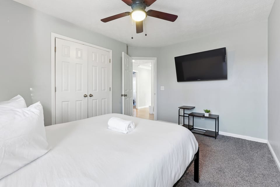 Cozy double bedroom with Smart TV and modern decor.