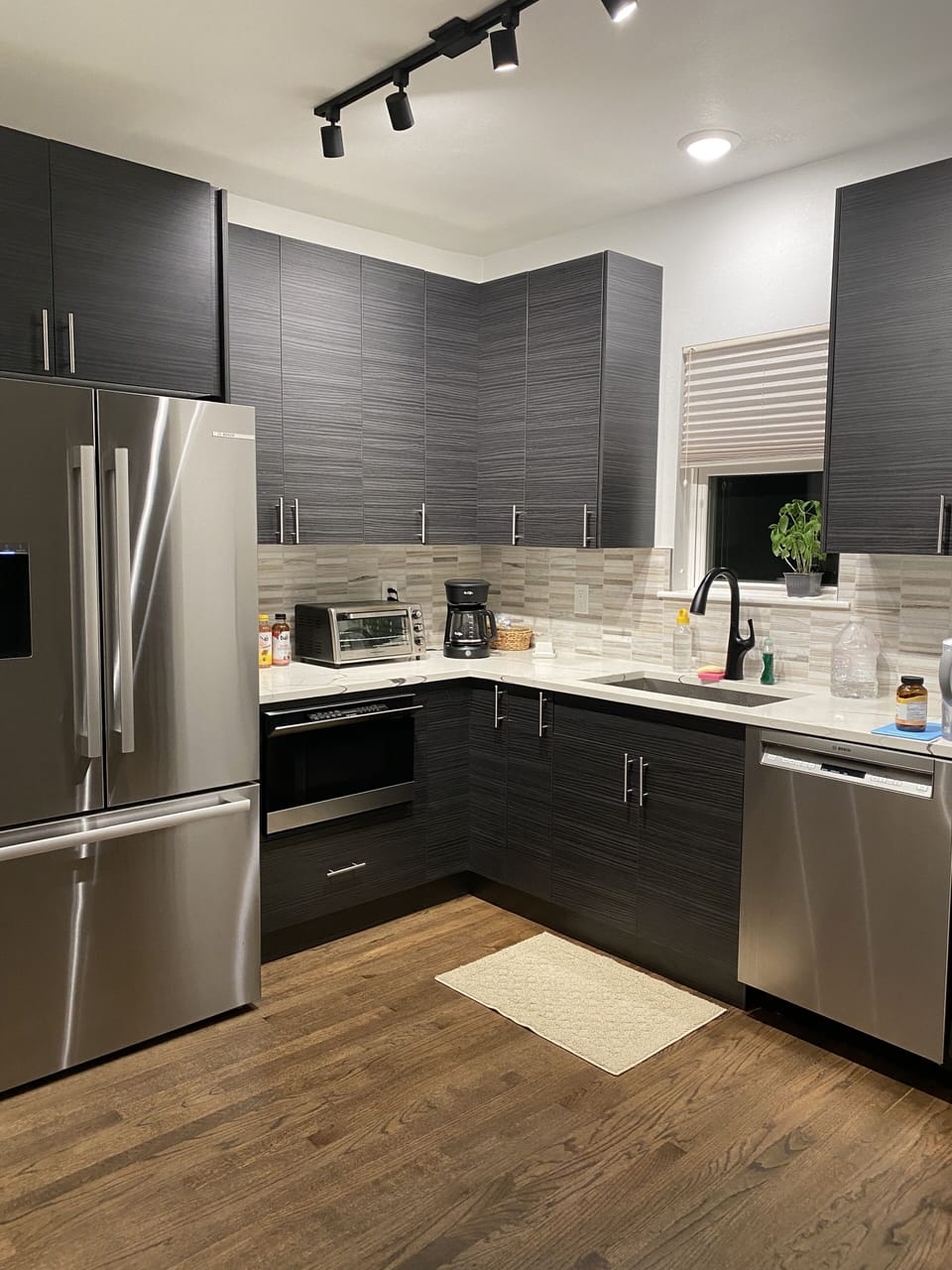 Kitchen with Bosch frig, dishwasher; air fryer, toaster, MrCoffee, Ninja FdProc.