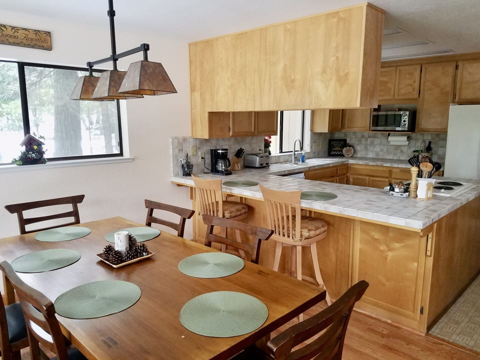 Bright and sunny dining room and kitchen area. Kids love to sit at the counter.
