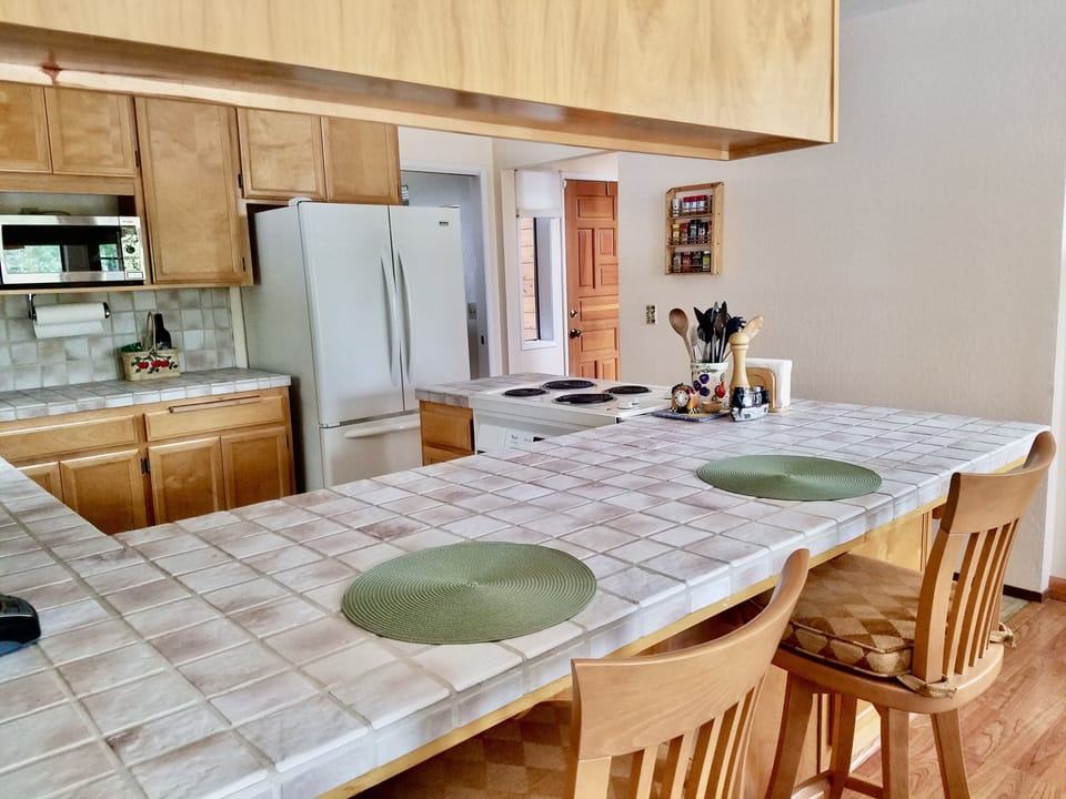Large kitchen counter with bar seating.