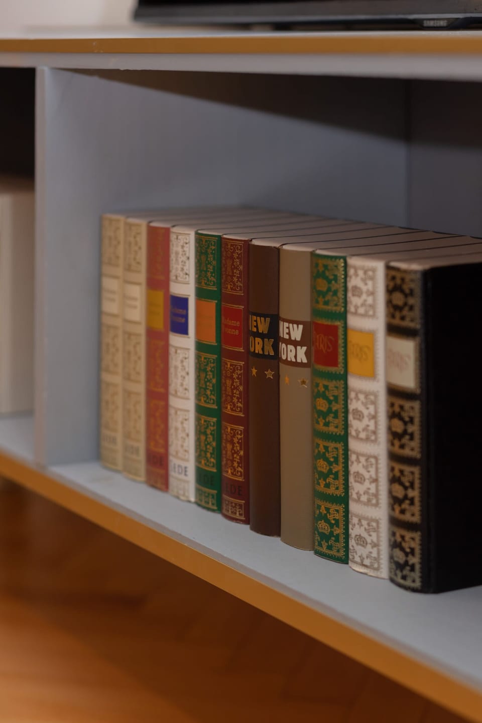 A bookshelf with neatly arranged books, adding a warm and intellectual touch to the interior.

