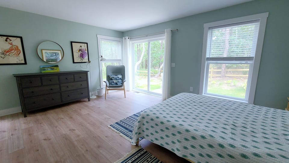 First floor bedroom with en suite bathroom and slider to patio