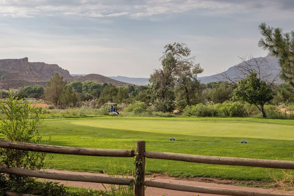 Famous Moab Rim in the distance. Mature trees and vegetation surrounding the unit.