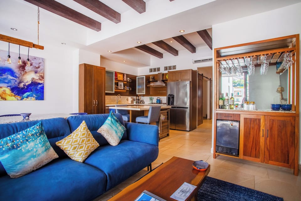 The living room has custom design furniture, smart TV and mini-bar