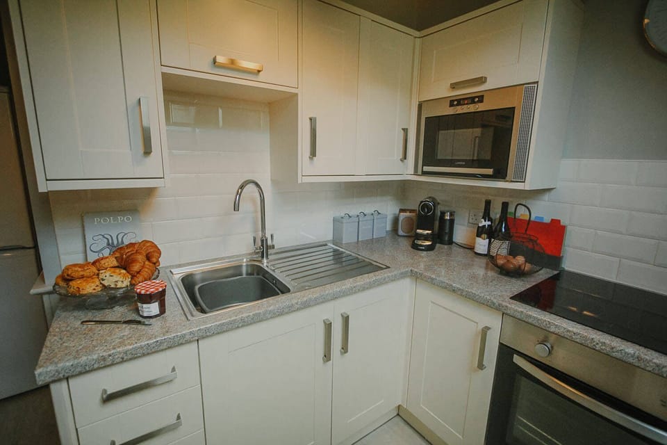 First floor: Kitchen with oven, 4 ring hob, microwave & fridge/freezer