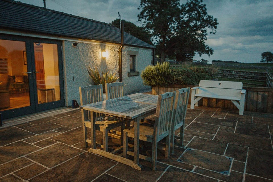 The sliding living room window gives access to a wide, level patio with barbecue and sensory garden