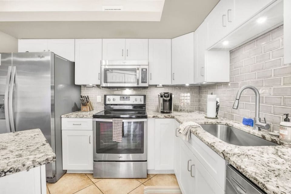 Kitchen and Sink area with island, k-kup coffee machine, and more