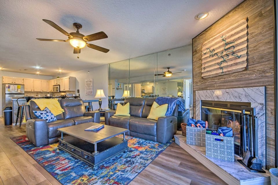 Relax in the spacious and stylish living area with plush seating and vibrant rug
