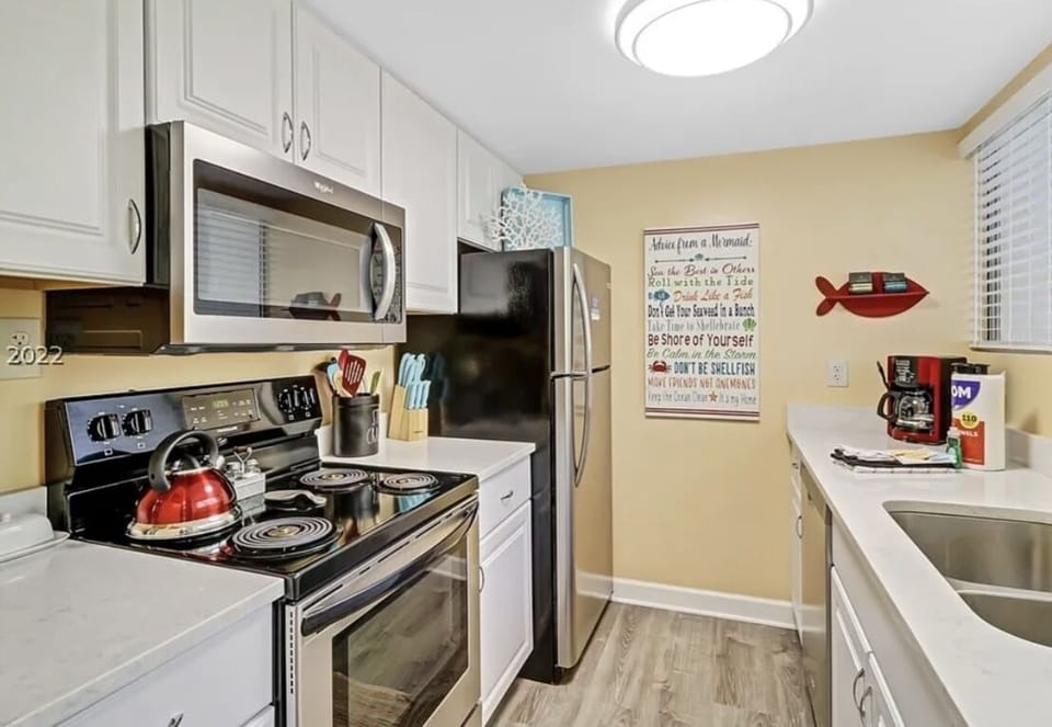 Kitchen with electric stove, microwave, refrigerator, and dishwasher 