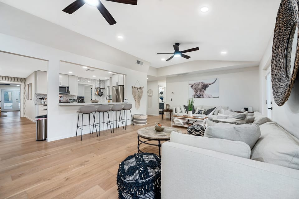 Open floor plan; living area and kitchen with barstools