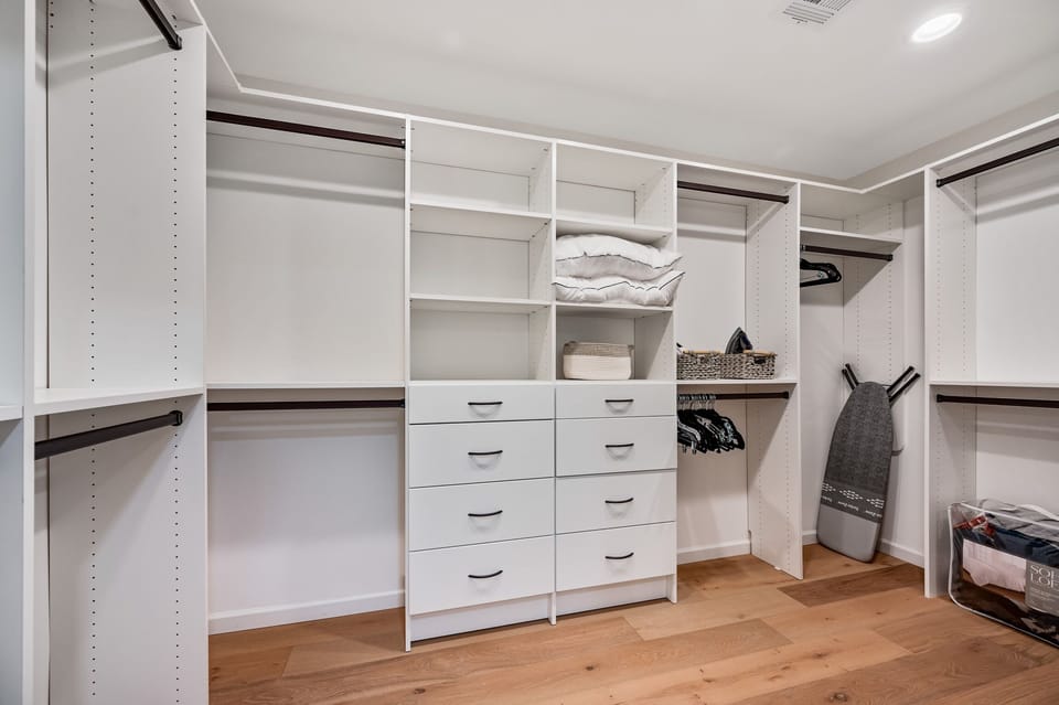 Primary walk-in closet with dresser drawers