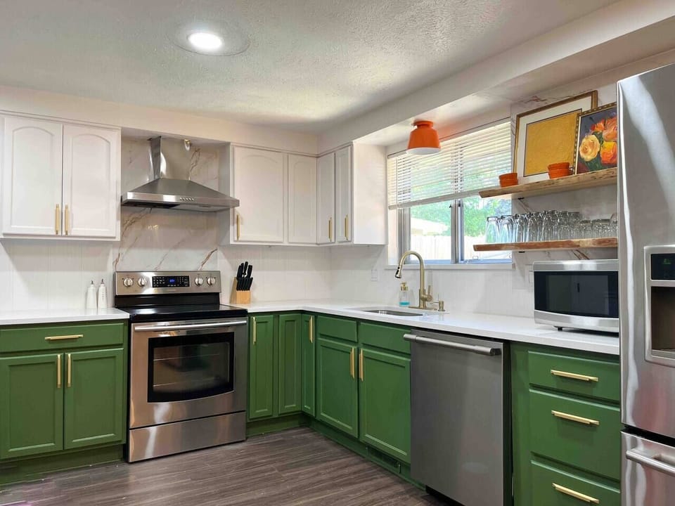 Kitchen is fully stocked with small appliances, serving ware and coffee/tea bar.