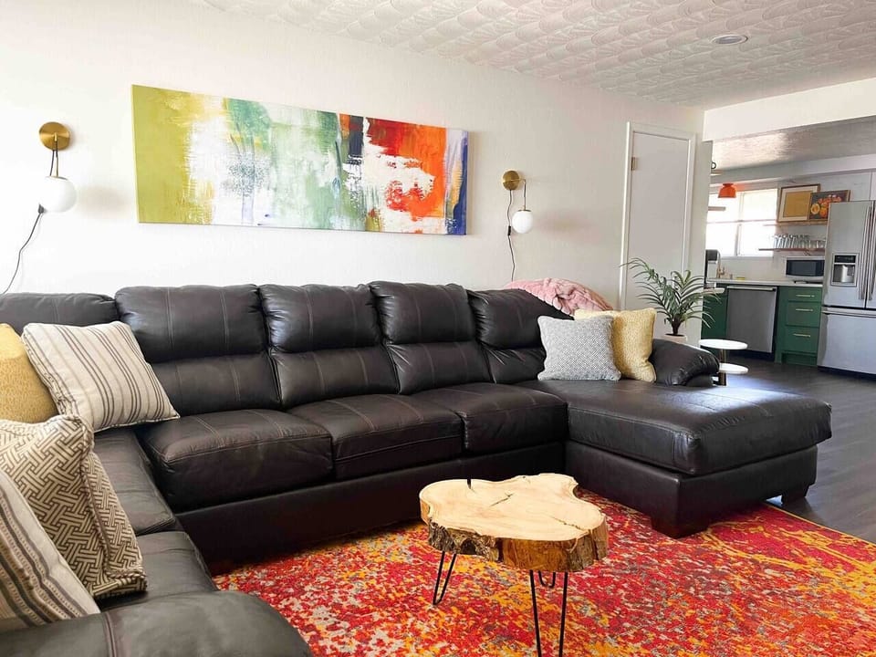 Very large sectional with 65” SmartTV in living room. Opens to dining room