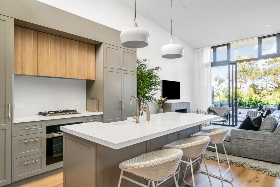 Beautiful kitchen with Miele appliances and double door fridge.