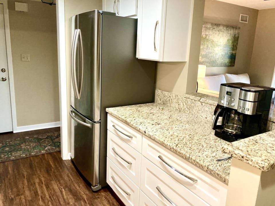 Coffee bar/prep area overlooks the den and dining area.