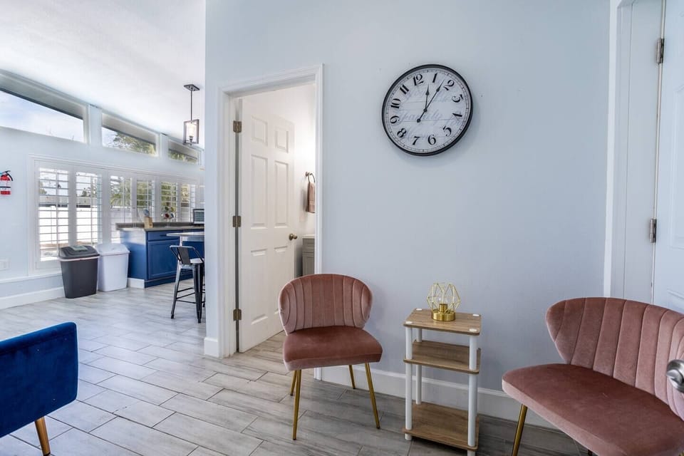 Living room with a sofa and two chairs. The space is bright