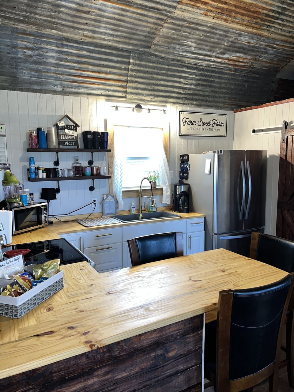 Kitchen with full stove, refrigerator, microwave, and all utensils 