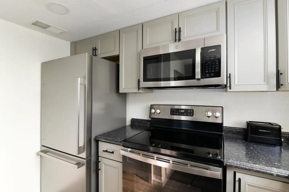 Full kitchen with appliances.