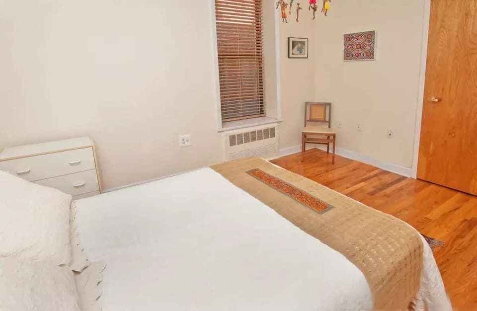 Master bedroom with window and closet