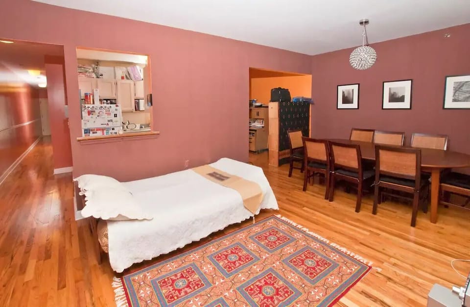 Living room shown with futon converted to extra bed