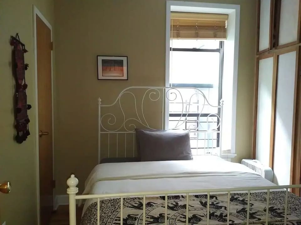 Second bedroom with window, closet and wall of built in storage