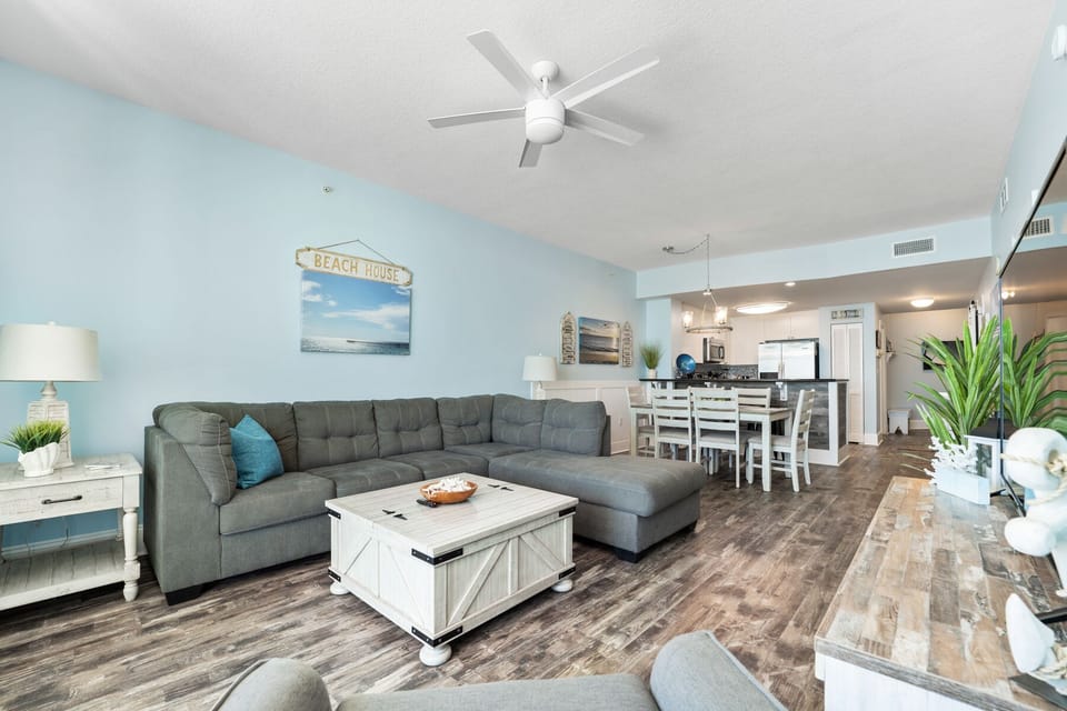 Relax in your bright, beach-themed living space with comfy sectional seating and coastal decor that makes every day feel like vacation.