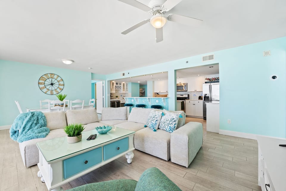 Sink into plush coastal comfort where turquoise accents and open design create your perfect beachside retreat.
