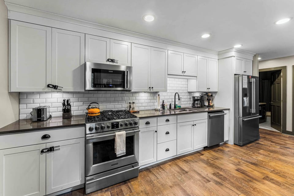 Fully equipped kitchen with modern appliances, plenty of counter space, and sleek cabinetry.