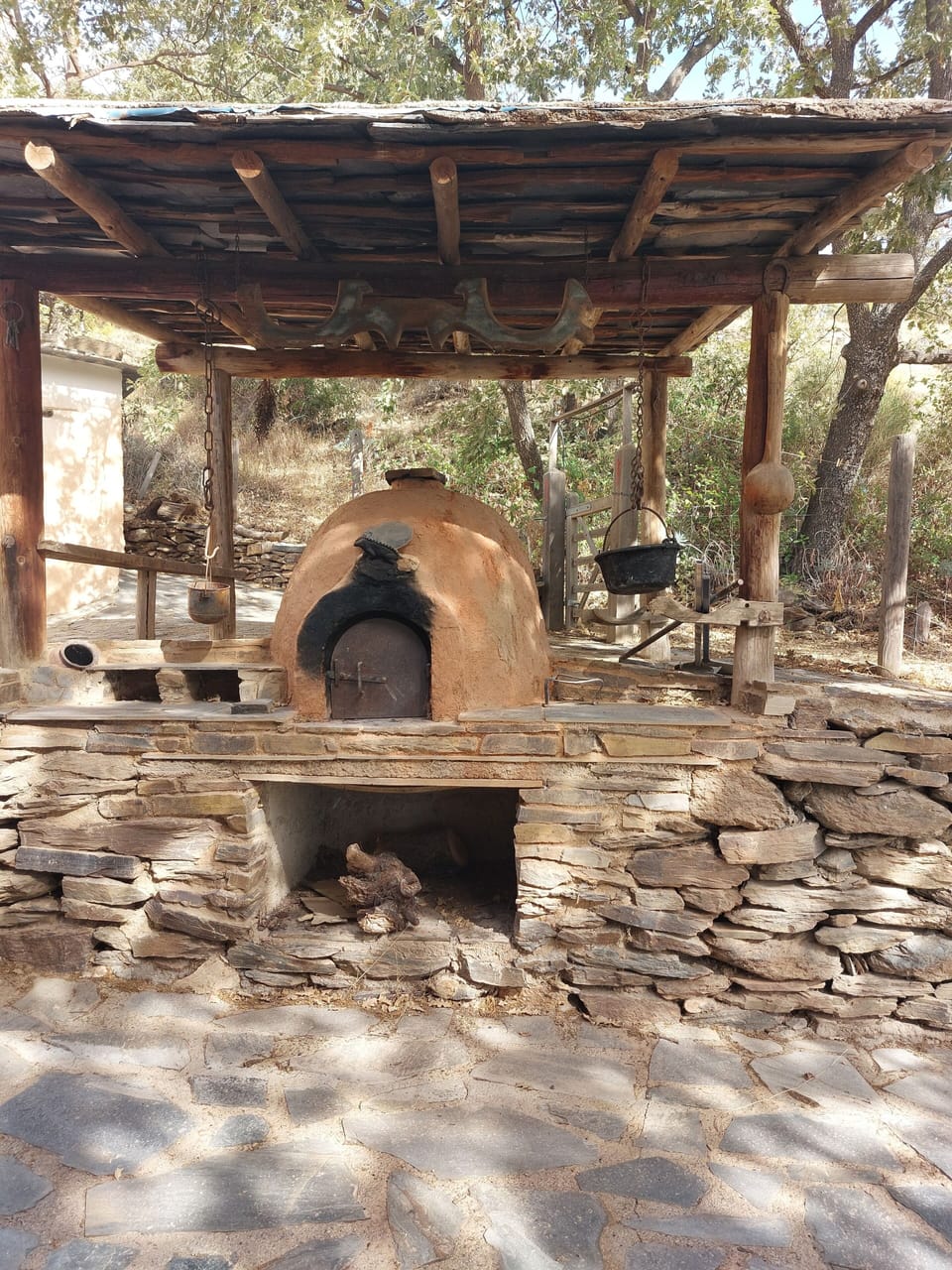 View of wood burning pizza oven behind Almond Cortijo.
