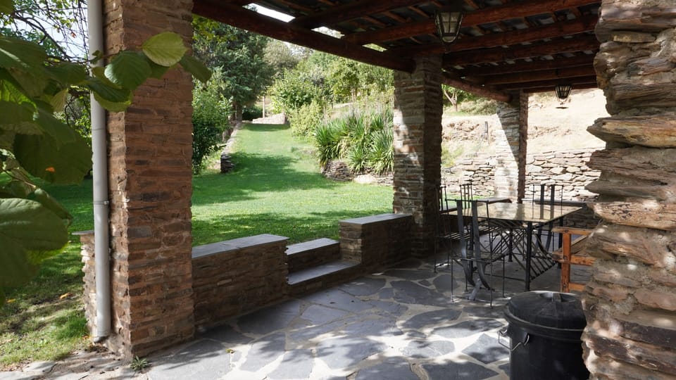 Covered terrace and eating area outside Almond cortijo looking towards the pool.