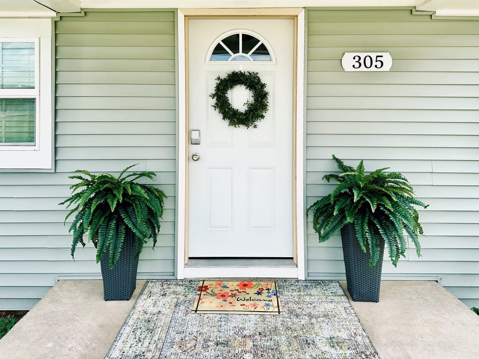 Fresh porch plants and rug - welcome!