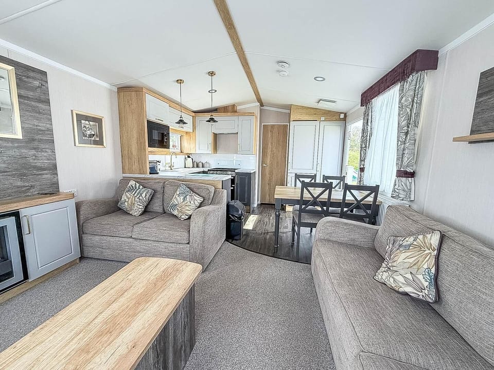 The living room in your holiday accommodation is both spacious and inviting, designed for comfort and relaxation.