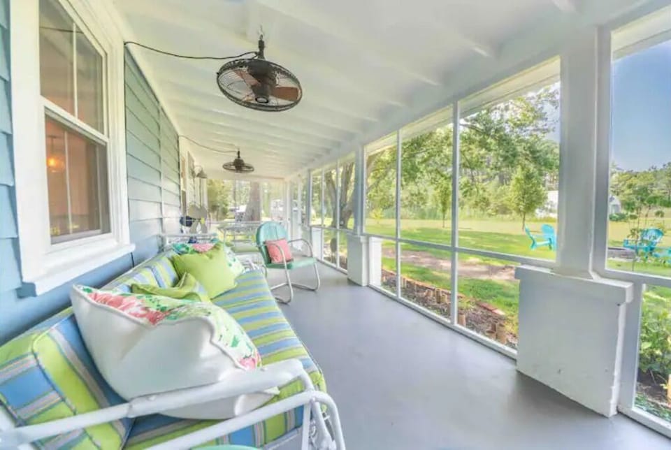 Screened porch with vintage glider. Perfect for naps or to enjoy the view. 