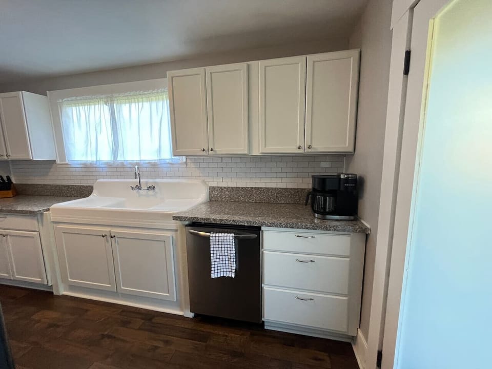 Charming farmhouse sink with the modern convenience of a dishwasher.