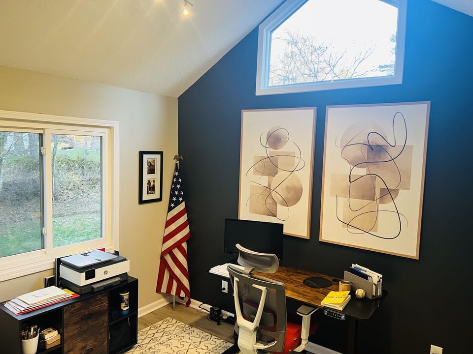 Private office with ergonomic chair and adjustable motorized desk 