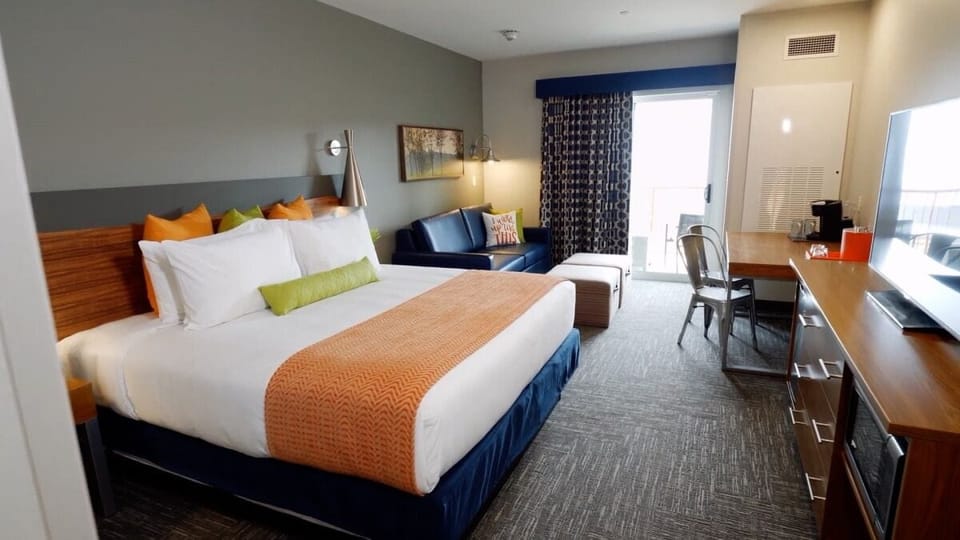 Unwind in a spacious king room with cozy lounge seating.