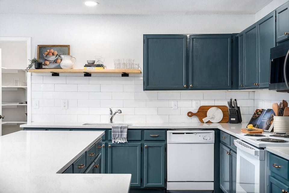Kitchen with dishwasher, GE fridge and oven. Plus coffee machine.