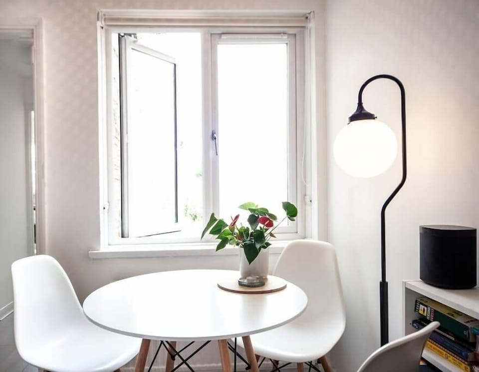 Conveniently positioned by the window, the dining table doubles as a perfect workspace.